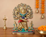 Brass Dakshinamurti Shiva statue, seated with raised hands and ornate halo