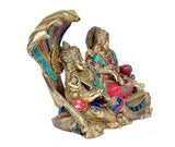 Brass Vishnu and Lakshmi idol at angle, Shesh nag hood behind, turquoise red accents