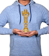 Person holding brass Deeplakshmi with parrot idol figurine on round base