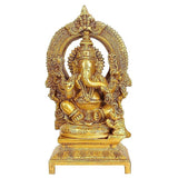 Gold brass Ganesha idol with ornate kirtimukha carved frame, 7 in height