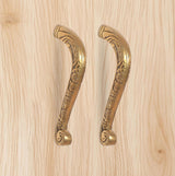 Golden brass main door pull handle pair with decorative floral engravings.