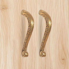 Golden brass main door pull handle pair with decorative floral engravings.