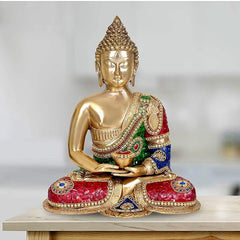 Gold brass Buddha meditation idol seated cross-legged, closed eyes and jeweled multicolor robe.