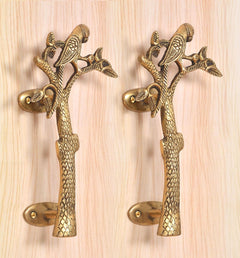 Brass parrot tree door handle pair with detailed branch and leaf motifs, curved bases