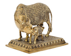 Brass cow with calf statue, back/side view, floral etched body and textured ground base