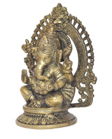 Brass Ganesha statue side view, seated posture, sweeping halo details, decorative base