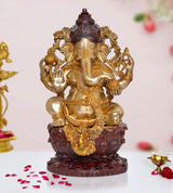 Brass Lord Ganesha idol, seated with ornate arms and dark red lotus base
