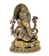Brass Ganesha statue angled view, detailed face jewelry, raised hands, patterned round base