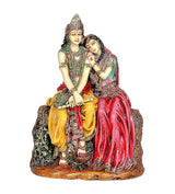 Resin Radha-Krishna figurine, colorful seated couple on textured base with detailed jewelry
