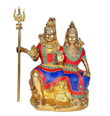 Brass Shiv-Parvati idol, blue and red mosaic robes, trident staff, seated