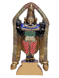 Back view of multicolored brass idol statue with patterned sash and raised arms