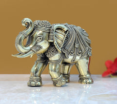 Brass elephant figurine in profile, carved saddle and ornaments, 5 in tall