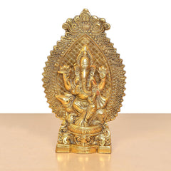 Gold metal Ganesha idol with detailed halo and raised ornaments, standing