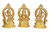 Three brass Hindu deity statues: Lakshmi, Ganesha, Saraswati, seated with arch frames