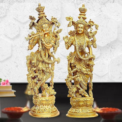 Brass Radha Krishna idol statues, side view of two standing figures with halos