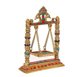 Brass swing jhula angled view, carved canopy and multicolor bead accents for Ladoo Gopal