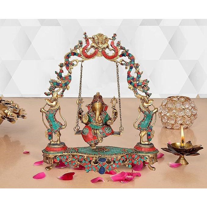 Brass Ganesha idol on swing with jeweled accents and two standing attendants