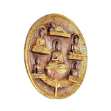 Brass circular Buddha wall plate, angled view of five seated mudra figures in relief