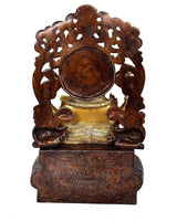 Back view Ganpati statue, carved dark support with round medallion base