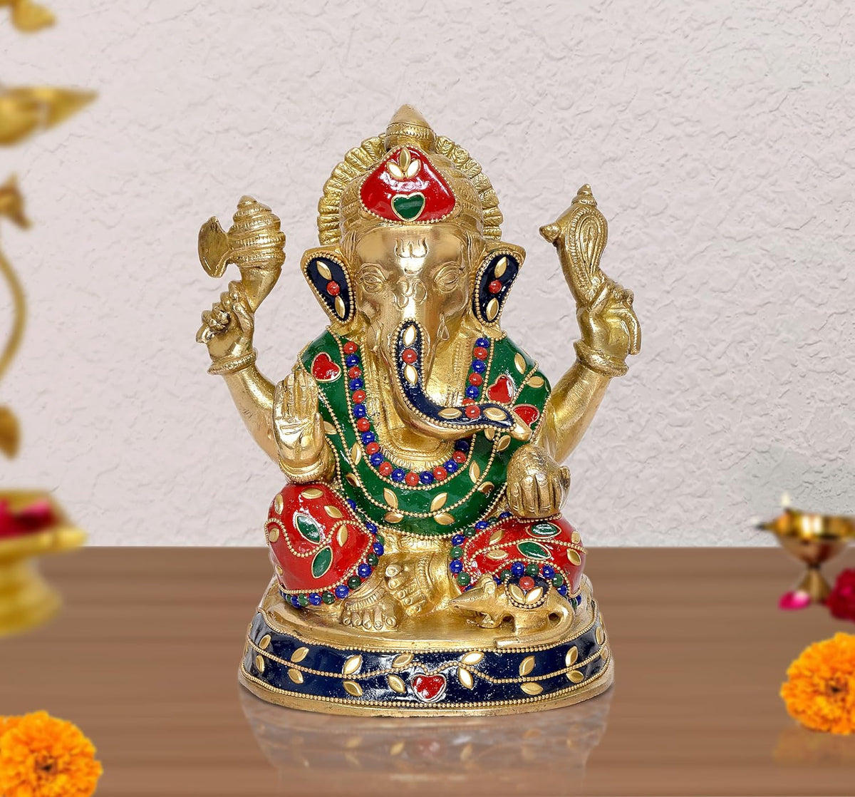 Brass Ganesha idol statue with red, green, and blue jeweled detailing, raised arms