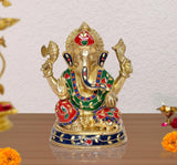 Brass Ganesha idol statue with red, green, and blue jeweled detailing, raised arms