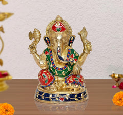 Brass Ganesha idol statue with red, green, and blue jeweled detailing, raised arms