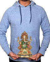 Brass Ganesha idol held in hands, multicolor enamel robe and jeweled crown visible