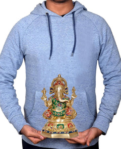 Brass Ganesha idol held in hands, multicolor enamel robe and jeweled crown visible