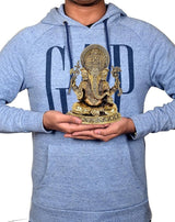 7 inch brass Ganesha idol in hands, seated figure with ornate crown and pedestal base