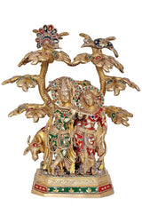 Front view Radha-Krishna brass idol with cow, colorful jewel accents, tree canopy