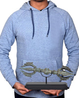Bronze eight-pronged Dorje on wooden base held by person, turquoise patina