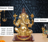 Brass Ganpati Bappa idol, gold-toned with red crown and multicolor accents on pedestal