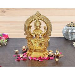 Brass Lakshmi idol, 10-inch, seated figure with tall halo and raised hands