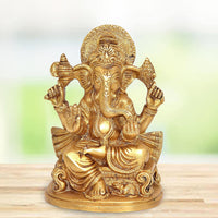 Brass Raja Ganesh idol statue, seated with four arms, decorative halo