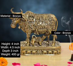 Bronze-finish Kamdhenu cow deity figure with calf, detailed ornate pedestal