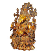 Brass Ganesha idol seated, detailed carvings and halo; side view
