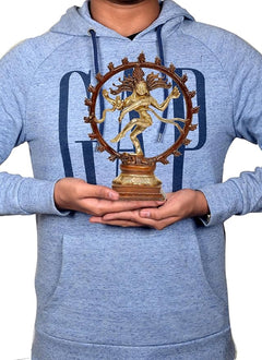 Brass Shiva Nataraj idol held in hands, circular halo ring on pedestal