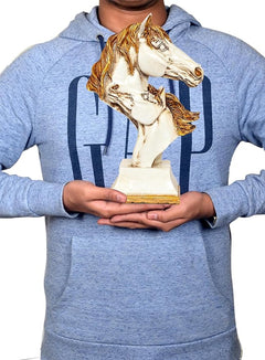 White polyresin double horse head statue held in hands, gold mane, on pedestal base