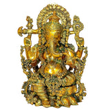 Gold-toned Ganesha statue close-up, detailed headdress and jewelry, four arms