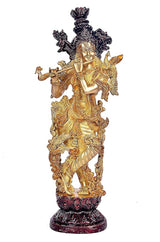 Brass Lord Krishna flute statue with detailed jewelry, dark crown accents, standing on base