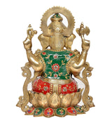 Brass Ganesha statue from behind, green back cloth with red base, gold arms