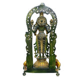 Brass Lakshmi idol with openwork arch and greenish base frame, rear view