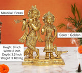 Brass Radha Krishna idol, golden color; peacock figure; 9-inch height.