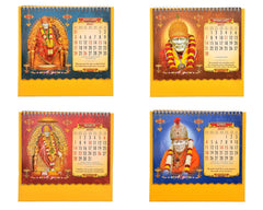 Tabletop calendar showing four 2027 monthly pages with Sai Baba portraits