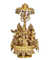 Brass Lakshmi, Ganesha and Saraswati idol, front view under parasol canopy