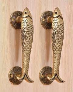Matched pair of golden brass fish door handles with round rosettes and screws.