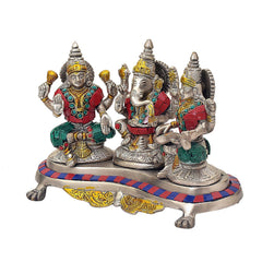 Ganesh-Lakshmi-Saraswati brass idol trio with jeweled red, green, and blue accents