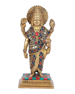 Brass Dhanvantari religious statue, blue and red jeweled attire, standing on pedestal