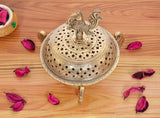 Golden brass loban dhoop dani with peacock finial, round perforated lid and legs