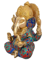 AONA Brass Ganesha idol with gold face and jeweled blue/red skirt, side view